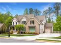 Beautiful home showcasing brick and siding exterior, attached garage, and professionally landscaped yard at 2622 Running River Ct, Lawrenceville, GA 30045