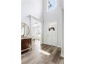 Elegant foyer with wood flooring, tall ceiling, white door, and view to the study at 2622 Running River Ct, Lawrenceville, GA 30045