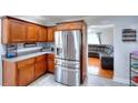 Modern kitchen featuring stainless steel refrigerator and plenty of storage cabinets at 1621 Dixie Rd, Covington, GA 30014