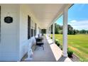 Inviting covered front porch with seating area, perfect for relaxing and enjoying the outdoors at 1621 Dixie Rd, Covington, GA 30014