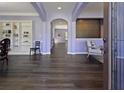Inviting living room with dark wood floors, archways, built-in shelving, and lots of natural light at 211 Parc Dr, Canton, GA 30114