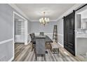 Charming dining room features gray walls, modern floors, and a stylish sliding barn door at 3910 Meeting St, Duluth, GA 30096