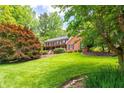 Beautifully landscaped front yard with lush green grass and mature trees surrounding the home at 4930 Forestglade Ct, Tucker, GA 30087