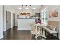 Bright living room boasts a small dining table, dark floors, and neutral colored walls at 1300 Dekalb Ne Ave # 731, Atlanta, GA 30307