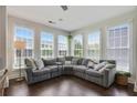 Bright living room boasts many windows and neutral colored L-shaped couch with patterned pillows at 1300 Dekalb Ne Ave # 731, Atlanta, GA 30307