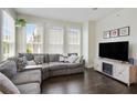 Bright living room boasts many windows and neutral colored L-shaped couch and fireplace at 1300 Dekalb Ne Ave # 731, Atlanta, GA 30307