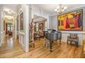 Elegant living area with gleaming hardwood floors, large painting, and decorative moldings at 2672 Brickell Square, Atlanta, GA 30341