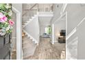 Bright foyer features new flooring, stairs to the second floor, and an open view to other rooms at 3220 Goldmist Dr, Buford, GA 30519