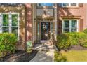 A welcoming front entrance, featuring brick accents and a decorative wreath on a dark-colored door at 3220 Goldmist Dr, Buford, GA 30519