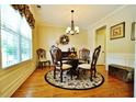 Formal dining room with hardwood flooring, elegant decor and plenty of natural light at 1005 Woodbury Rd, Canton, GA 30114