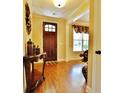 Home foyer featuring a hardwood floor, decorative table and traditional front door at 1005 Woodbury Rd, Canton, GA 30114