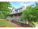 Well-maintained home with a spacious wrap-around porch and mature trees in a serene setting at 21 Wisteria Run, Hiram, GA 30141