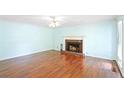Spacious living room with a brick fireplace and hardwood floors, offering a cozy ambiance at 21 Wisteria Run, Hiram, GA 30141