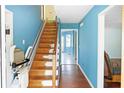Stairway with hardwood steps and a lift, leading to the upper level, bright blue walls at 21 Wisteria Run, Hiram, GA 30141