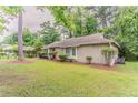 Side view of home with well-maintained lawn, mature trees, and a brick and siding exterior at 2469 Newgate Dr, Decatur, GA 30035