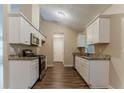 Bright kitchen with white cabinets, granite countertops, stainless steel appliances, and wood flooring at 2469 Newgate Dr, Decatur, GA 30035