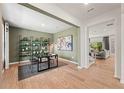 A stylish office with a desk, shelving, light green walls, and hardwood floors at 720 Hedwig Dr, Mcdonough, GA 30252