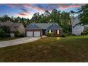 Attractive exterior view of home with driveway, green lawn, and blue sky at 10 Bayberry Ct, Acworth, GA 30101