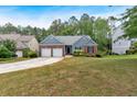 Inviting home with well-manicured lawn, two-car garage, and mature trees at 10 Bayberry Ct, Acworth, GA 30101