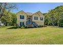 Charming two-story home with a well-manicured lawn and mature trees surrounding the property at 2821 Highway 11, Mansfield, GA 30055