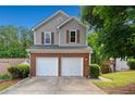 Charming home with a two-car garage, brick accents, neutral siding, and well-maintained landscaping at 164 Stoneforest Dr, Woodstock, GA 30189