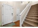 Inviting foyer featuring hardwood floors, a staircase with white railing, and a front door at 164 Stoneforest Dr, Woodstock, GA 30189