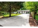 View of the home's exterior featuring a long driveway and mature trees at 1819 Waldrep Se Cir, Marietta, GA 30060