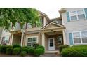 Inviting townhome showcasing charming exteriors and well-manicured landscaping, complete with a stone-accented entryway at 2476 Suwanee Pointe Dr, Lawrenceville, GA 30043