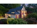 Lovely two-story home featuring a brick facade, attached garage, and mature landscaping at 3102 Royal Troon, Woodstock, GA 30189