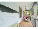 Nautical-themed front porch featuring a whale decoration and a comfortable egg chair with a dog at 621 Mcgruder Ne St, Atlanta, GA 30312