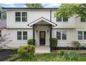 Inviting front porch with black door, contrasting trim, and manicured bushes at 146 Mount Paran Ne Rd, Atlanta, GA 30342