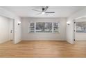 Bright living room features hardwood floors, modern ceiling fan, and ample natural light from a large window at 201 E Simon Nw Ter, Atlanta, GA 30318