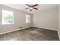 Bright bedroom featuring wood-look flooring, neutral walls, and a ceiling fan at 8857 Ashwood Dr, Riverdale, GA 30274