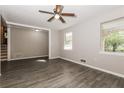 Open-concept living room with wood-look flooring, neutral walls, and ample natural light at 8857 Ashwood Dr, Riverdale, GA 30274