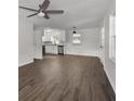 Bright living room features new wood floors, a ceiling fan, and is open to the white kitchen at 10 Casey Ln, Cartersville, GA 30121