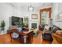 Spacious living room with hardwood floors, a fireplace, and comfortable leather seating at 132 Eagles Club Dr, Stockbridge, GA 30281