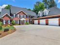 Brick home with a three-car garage and a large driveway at 219 Eagles Landing Way, Mcdonough, GA 30253