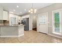 Eat-in kitchen featuring tile floors, granite counters, and stainless appliances at 2312 Mahogany Glen Pl, Lawrenceville, GA 30043