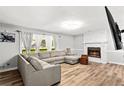 Bright living room featuring a fireplace, wood-look floors, and a comfortable sectional sofa at 5006 Dekalb Way, Stone Mountain, GA 30087
