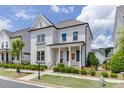 Attractive two-story home boasts a well-maintained lawn, lush landscaping, and classic architectural details at 1023 Harvest Park Ln, Suwanee, GA 30024