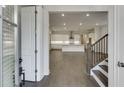Inviting interior showcases hardwood floors, an open floor plan, and modern kitchen with bright white cabinetry at 1023 Harvest Park Ln, Suwanee, GA 30024