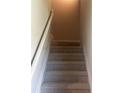 Carpeted stairs with white railing and neutral wall paint, leading to the next level at 1151 Park Center Cir, Austell, GA 30168