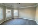 Bright bedroom with carpet, baseboard trim, neutral walls, and abundant natural light at 265 Sanctuary Dr, Lawrenceville, GA 30046