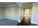 Elegant home foyer featuring hardwood floors, crown molding, and an open floor plan at 265 Sanctuary Dr, Lawrenceville, GA 30046