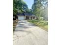 Single story home with an attached garage and a long concrete driveway at 2661 Throatlatch Sw Ln, Marietta, GA 30064