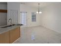 Open-concept dining area featuring marble floors and a stylish chandelier at 5090 Leeshire Trce, Tucker, GA 30084