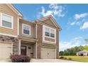 Well-maintained two-story townhome with attached garage and a welcoming front yard at 6315 Princeton Ridge Dr, Lithonia, GA 30058