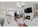 Bright, open-concept living room with fireplace flowing seamlessly into a modern kitchen with island seating at 6315 Princeton Ridge Dr, Lithonia, GA 30058