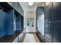 Well-organized mudroom featuring custom blue built-in cabinets, drawers, shelving, and a patterned rug at 444 Rock Springs Ne Rd, Atlanta, GA 30324