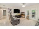 Bright living room with light floors, modern ceiling fan and lots of natural light at 502 Brighton Pt, Atlanta, GA 30328